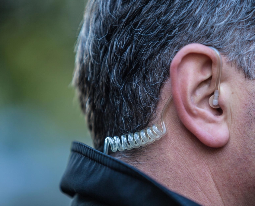 Side view of a man with an earpiece in