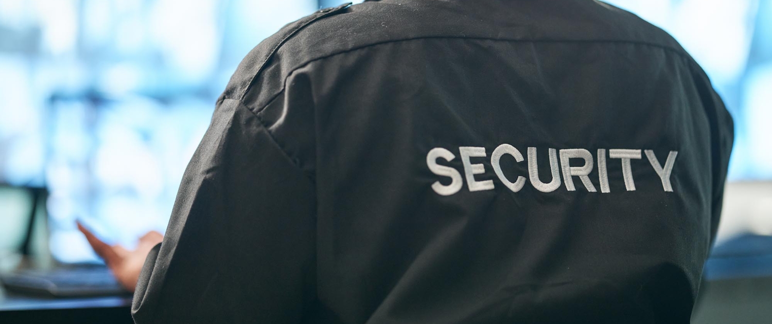 Back view of a man with a security jacket on