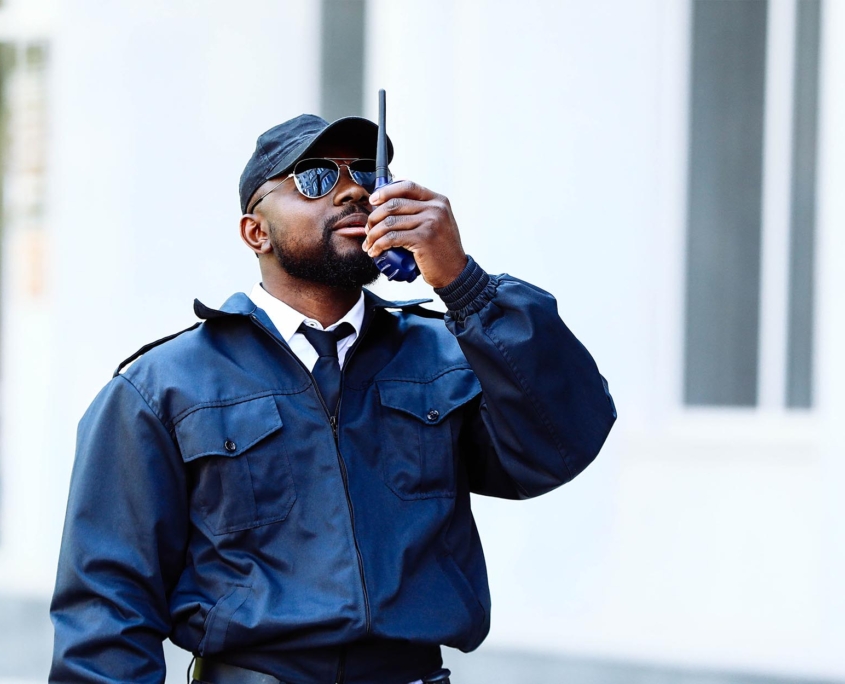 Front view of a security guard talking on communication device