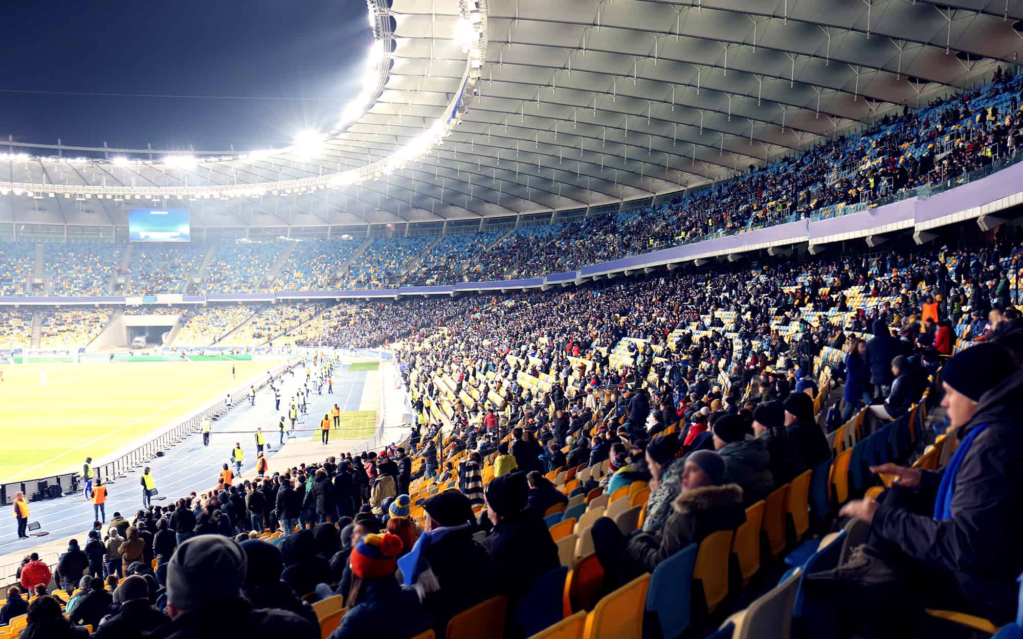 Wide view of fans watching football in a stadium