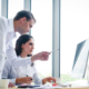 Senior businessman give advise to another businesswoman on a serious project in office
