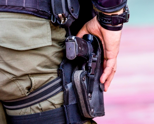 Armed security guard with hand on holster