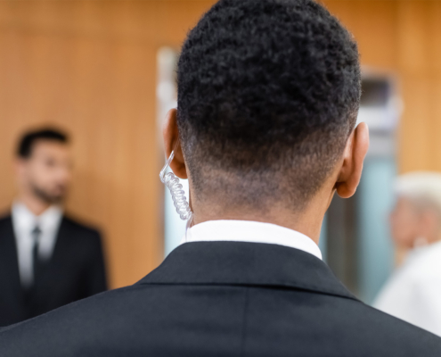 Back view of security guard with headset on, bodyguard