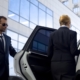 Security guard opening car door for high-profile person