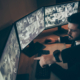 Side view of man in suit observing CCTV footage with serious face
