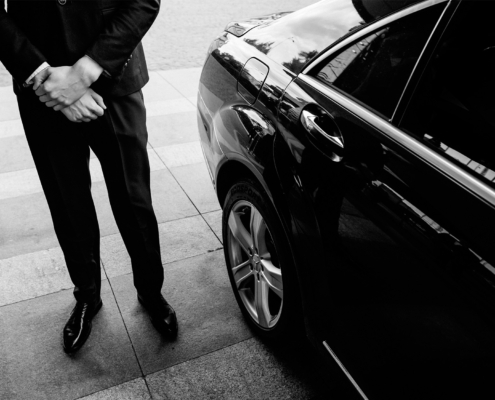 Valet's Hand Opening Grey Car Door On Street