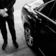 Valet's Hand Opening Grey Car Door On Street