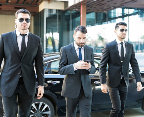 Private Security Bodyguards Walking By Businessman