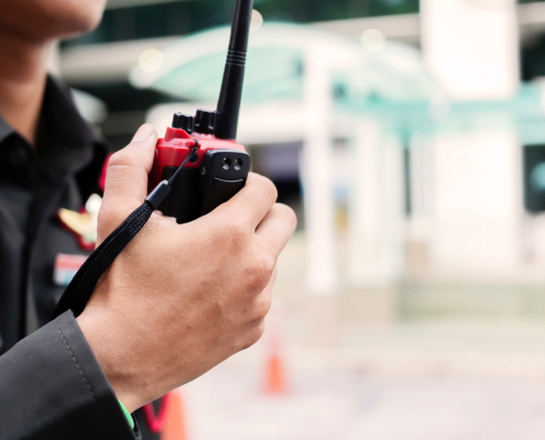 Security guard uses radio communication for facilitate traffic