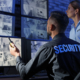 Two workers looking at security camera feed