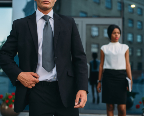 Bodyguard in suit and sunglasses, female VIP