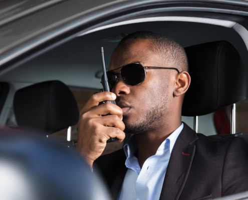 Man Sitting Inside Car Talking On Walkie Talkie