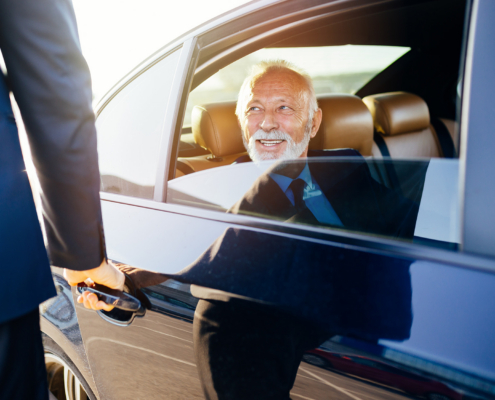 Senior business man sitting in his limousine