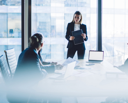 Businesswoman presenting project to coworkers in office